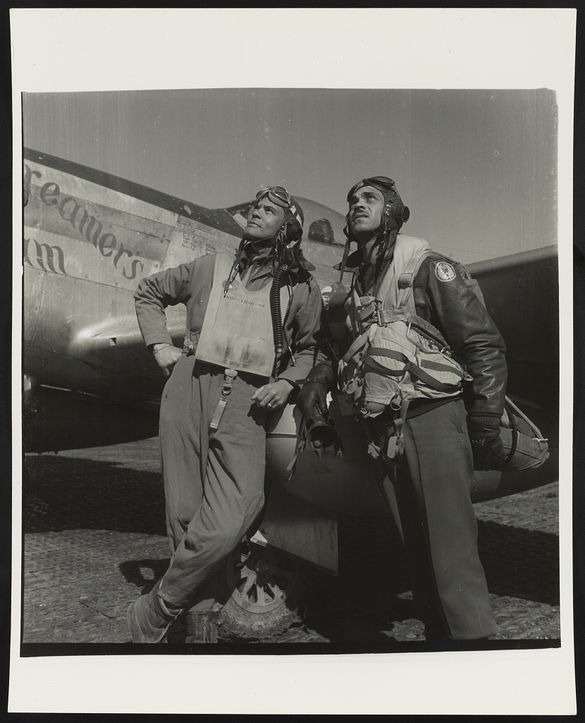 Photograph shows (left) Col. Benjamin O. Davis, Commanding Officer, 332nd Fighter Group, Class 42-C; (right) Edward C. Gleed, Lawrence, KS, Class 42-K, Group Operations Officer. P-5/D in background, "Creamer's Dream," generally flown by Charles L. White, St. Louis MO, Class 44-C Ramitelli, Italy, March 1945. 
