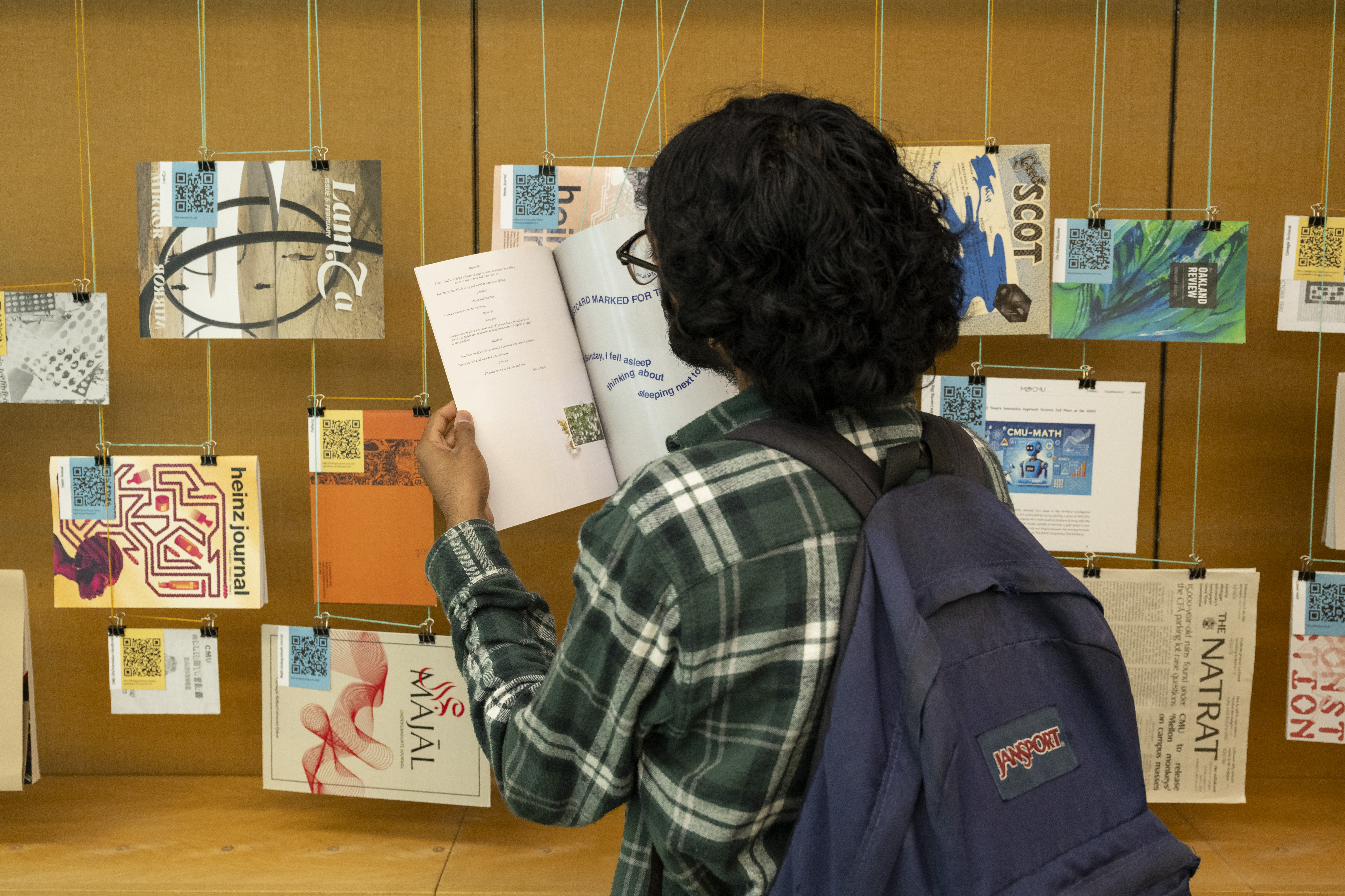 student browsing hanging publications